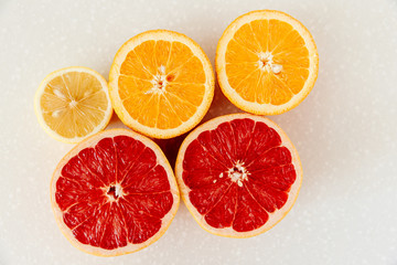 Half of grapefruit, orange, lemon cut for fresh juice. Color splash. Tropical fruits