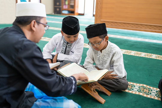 Kid Learning To Read Quran With Muslim Teacher Or Ustad