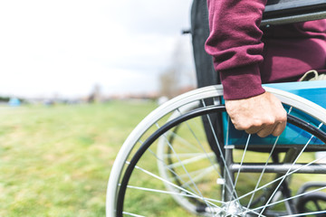 Naklejka premium Close Up of Man on Wheelchair Outdoors.