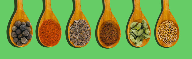 top view set of spices flat lay web site banner   isolated on green background