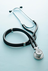 Coiled stethoscope on a blue background