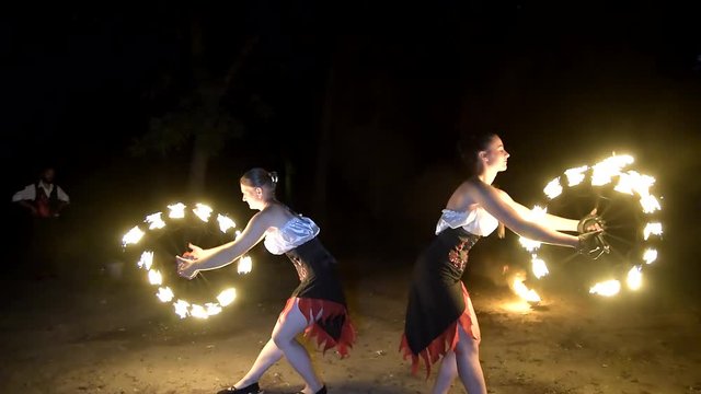 Spinning fire by firedancers at night