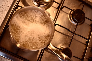 A pan of boiling water ready to start cooking dinner of the gas stove
