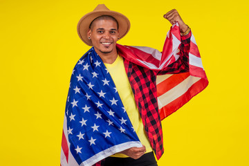 Fototapeta premium american man wrapped on flag looking at ca,era and snow-white smile