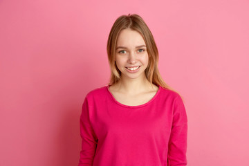 Obraz premium Smiling cute. Caucasian young woman's portrait isolated on pink studio background, monochrome. Beautiful female model. Concept of human emotions, facial expression, sales, ad, trendy.