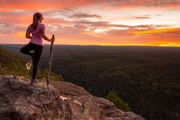 Woman serenity yoga while watching magnificent sunset