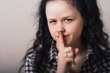 Naklejka premium young woman making silence gesture, shhh!!