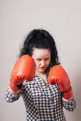 businesswoman with boxing gloves ready for fighting