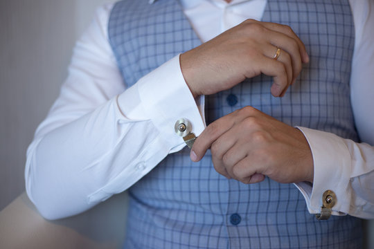 Man Fastens Cufflinks On A Shirt