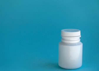 pill jar on a blue background