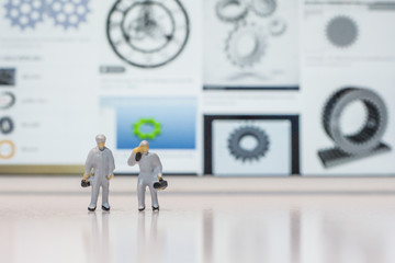 Miniature people engineer service team standing on a white ground