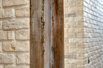 A fragment of the wall lined with white brick.