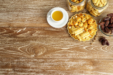 image of snack for breaking the fast. traditional islamic snack asian nastar served with tea over wooden background