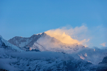 Beautiful snowy mountains in the evening at sunset. Light from the setting sun on the mountains. India