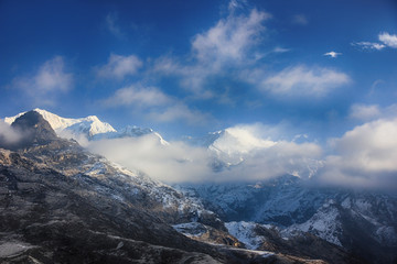 Beautiful mountains in the sun in clouds and haze. Light from the sun on the mountains. India