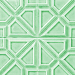 Blue green ceramic tile with geometric pattern for wall and floor decoration. Concrete stone surface background. Texture with ornament for interior design project.