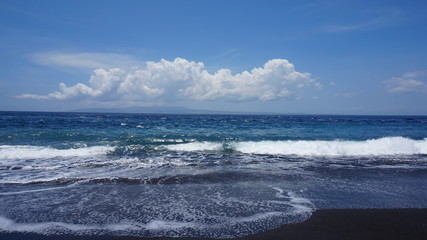 The beaches of the island of Bali. Black sands