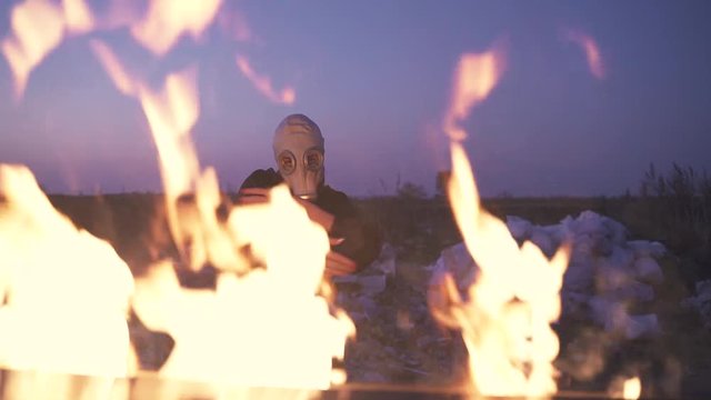 girl in gas mask dancing in flames