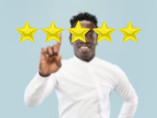 Man touching five star symbol to increase rating of company, app or service. Leaves his rate for...