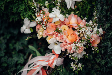 Beautiful wedding bouquet on the green grass on a summer day