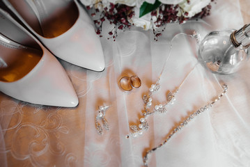 Wedding rings and other accessories close-up during the bride's gathering. Wedding