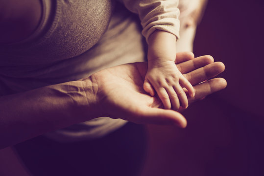 Mother and son join hands at home.