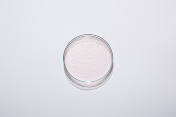 Top view of laboratory glassware with pink liquid on grey background