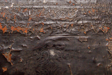 An old leather dark brown cover of an old book with cracks and peeling paint. Texture, background.