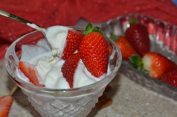 Sweet and delicious dessert. Ice cream sundae with strawberries in a crystal vase. Close up