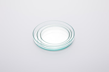 High angle view of laboratory Petri plates set on grey background