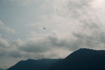 Fototapeta na wymiar Como, Italy. Airplane above lake.