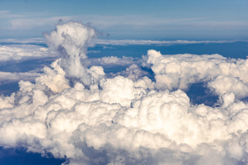 Clouds from the plane window. Beautiful sky and sea of clouds, photo from above. Various forms of...