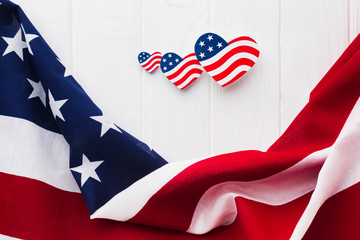 Fototapeta na wymiar Flat lay heart-shaped american flags for independence day