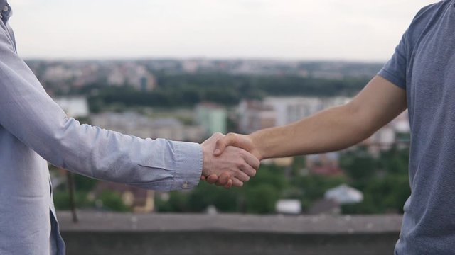 Business partners shaking hands after contractual negotiations close-up