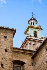 Fototapeta na wymiar roof of old spanish church with cross, background with historical building 
