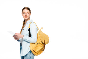pretty student with backpack using digital tablet and looking away isolated on white