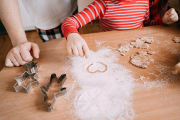 Father and son baking ginger cookies together at home kitchen. Flat lay photo.