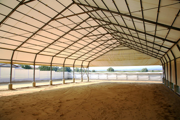 Empty riding arena is suitable for dressage horses