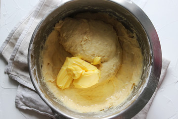 Put the yeast dough with butter in a large metal bowl. Homemade cake. Concept of homework during the quarantine period.