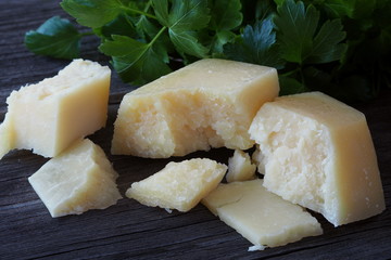 Pecorino sheep cheese and fresh herbs on a rustic wooden table.