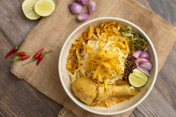 Khao Soi Chicken, Northern Thai Food on the wooden table - Stock photo