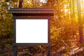 Blank white information board in the forest