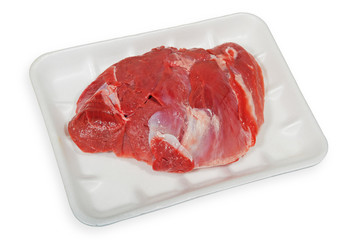 Raw meat in packaging isolated on a white background.