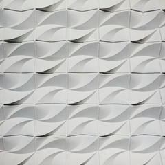 Abstract detail of white wavy lined plaster street wall texture on the facade of a vintage concrete east german building in Berlin.