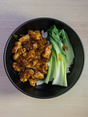 A bowl of Lu Rou Fan, taiwanese braised pork belly, with bok choy.