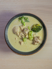 A bowl of green curry chicken.