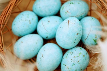 Blue chocolate easter eggs in nest Selective focus