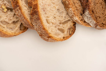 top view of fresh whole wheat bread slices on white background