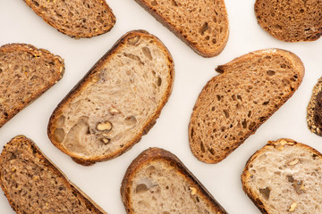 top view of tasty whole wheat bread slices on white background