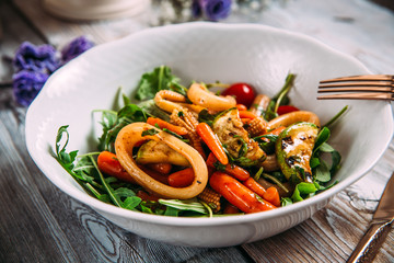 Seafood salad with vegetables and squid rings